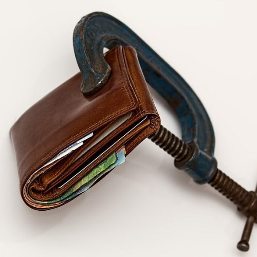 folded wallet in a vice grip